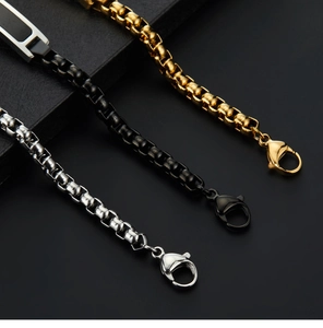 Three Cuban link bracelets in gold, black, and silver finishes with lobster clasps