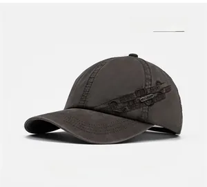 Close-up of the metal logo plate and SPORT embroidery on the side of the washed baseball cap