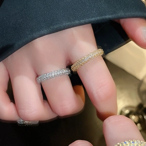 Close-up of gold and silver plated twisted rings with triple-row micro-pave zircons