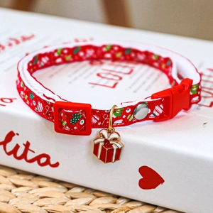 Detail of red Christmas pet collar with nylon webbing and enamel gift box pendant