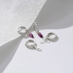 Macro shot of 925 sterling silver water-drop earrings with purple and clear zircon stones