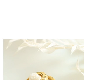 Macro detail of a golden U-shaped ring featuring elegant white round pearl textures