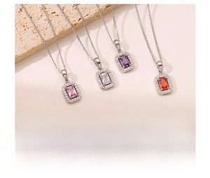 Macro shot of colorful square zircon pendants in pink, white, purple, and orange titanium steel