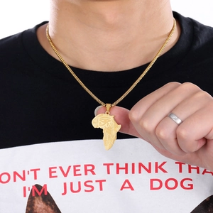 Male model wearing golden Africa map pendant with Eye of Horus on fine link chain