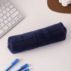 Macro view of blue quilted velvet pencil case with soft checkerboard pattern and zipper
