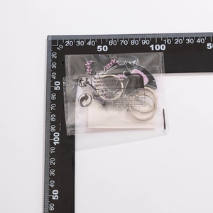 Close-up of Kuromi character keychain with bow and star charms in packaging