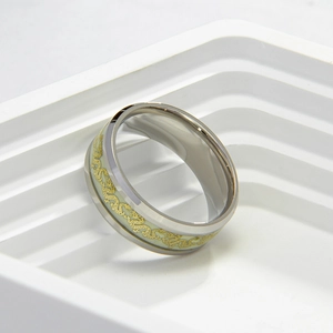Detailed macro view of the luminous dragon pattern on a polished steel band