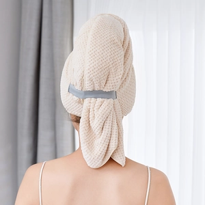 Detail view of microfiber waffle-weave hair towel wrap with an adjustable gray loop button