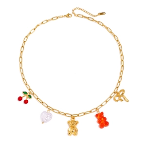 Golden pearl necklace featuring cherry, bear, and bow charms on white background