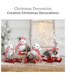 Detail of Christmas figurines with squirrels and bears on red wooden sleds for tabletop