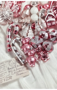 Close-up of pink and silver Christmas ornaments featuring bears, candy canes and glitter balls