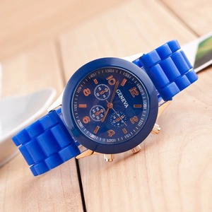 Close-up of blue silicone strap watch with rose gold case on a wooden surface