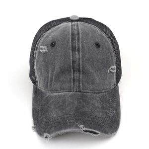 Close-up of washed charcoal baseball cap showing distressed torn details and mesh back