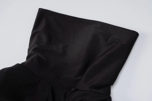 Detailed macro view showing the high-quality stitching and elastic fabric of the black dress