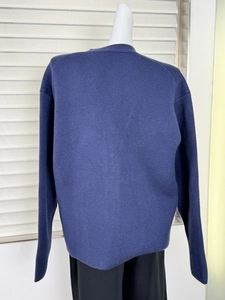 Detailed back view of navy blue chunky knit cardigan featuring thick textured cotton fabric