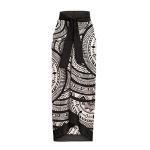 Detail of a tribal wrap skirt featuring black and white geometric patterns and waist tie