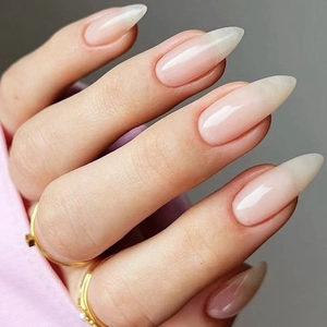 Glossy almond shaped nude press-on nails with shiny jelly texture finish