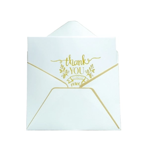 Elegant white greeting card with gold foil 'Thank You' text and matching gold border envelope