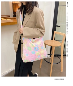Close-up detail of plush material and colorful floral patterns on a lady tote bag