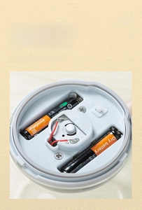 Detail view of the battery compartment on the base of the automatic stirring coffee mug