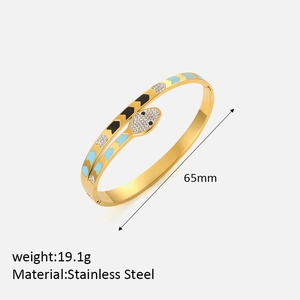 Detail of gold snake bangle showing 65mm diameter, 19.1g weight, and stainless steel mark