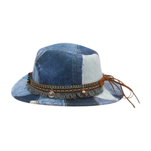 Detail of patchwork denim fedora featuring ethnic woven band and metallic coin pendants