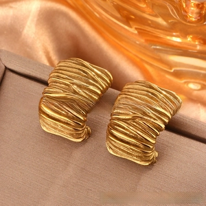 Detailed view of vintage gold-plated titanium steel earrings with wavy pleated texture