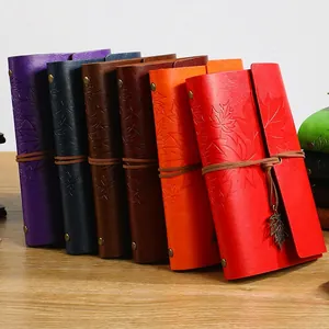 Vintage leather travel journal with maple leaf texture and metal pendant in multiple colors