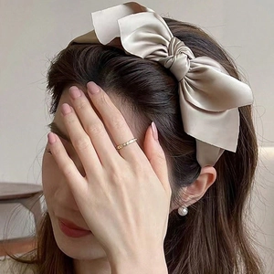 Elegant beige satin double-layered bow headband for women shown on model for a stylish look