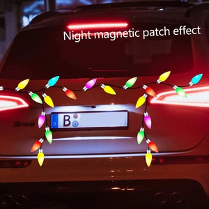 Night view of colorful magnetic Christmas bulb stickers on a white SUV vehicle