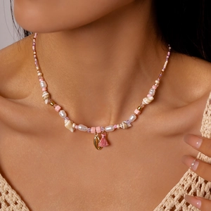 Bohemian style beaded necklace with faux pearls and seashells on a female model