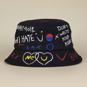 Close-up of black bucket hat with colorful street graffiti print and artistic hand-drawn patterns