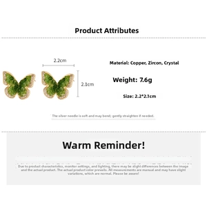 Detail view of butterfly earrings with green zircon and crystals showing size 2.2x2.1cm