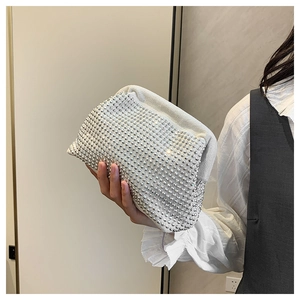 Chic cloud-shaped evening bag with silver rhinestones held by a model in casual attire