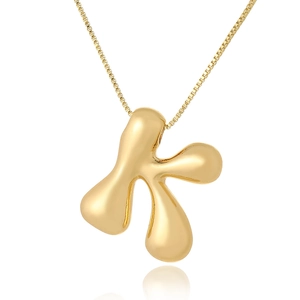 Close-up of golden bubble letter K pendant with polished liquid metal finish on a box chain