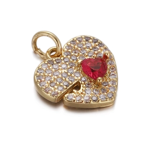 Macro view of gold heart pendant with red crystal and pavé rhinestones for DIY jewelry