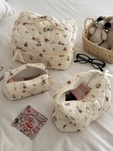 Detailed set of three quilted rabbit pattern cosmetic bags with circus prints and handles