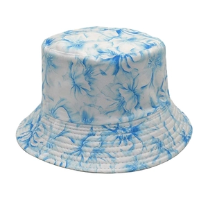 Detail of blue floral print on white sun hat with reinforced stitching on the brim