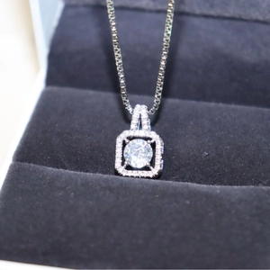 Silver square zircon pendant necklace featuring a large central stone and pave halo design