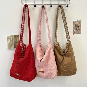 Three plush lamb wool tote bags in red, pink, and brown with plaid straps and drawstrings