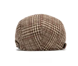Detailed back view of a plaid newsboy hat with a bronze metal adjustable side buckle