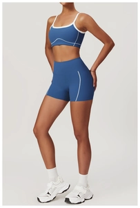 Close-up of royal blue yoga set featuring white piped sports bra and high-waist shorts