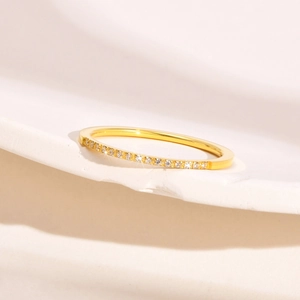 Close-up of 1mm gold stainless steel ring with micro-pave multicolored cubic zirconia stones