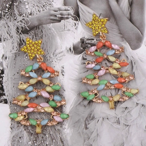 Detail of gold alloy Christmas tree earrings with colorful rhinestones on a fashion sketch