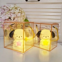 Two cartoon dog night lights in glowing warm yellow with elegant gift box packaging