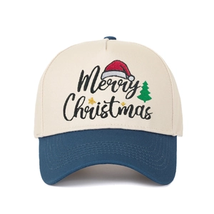 Detail of Merry Christmas embroidery on cream and navy blue baseball cap with stars