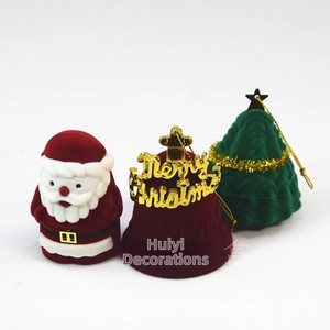 Detailed view of velvet Santa, bell, and Christmas tree shaped jewelry gift boxes