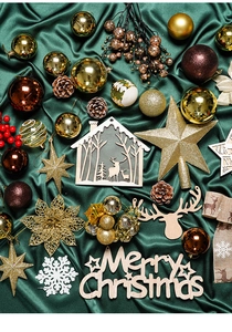 Flat lay of gold Christmas baubles, pine cones, and reindeer wooden crafts on green satin