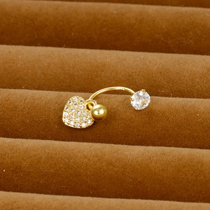 Close-up of gold heart-shaped zircon belly ring with S925 hallmark on a velvet tray