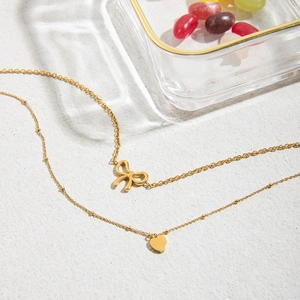 Double-layered 18K gold stainless steel necklace with bow and heart pendants